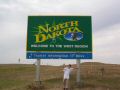 Hunter in North Dakota (love the bullet holes).jpg